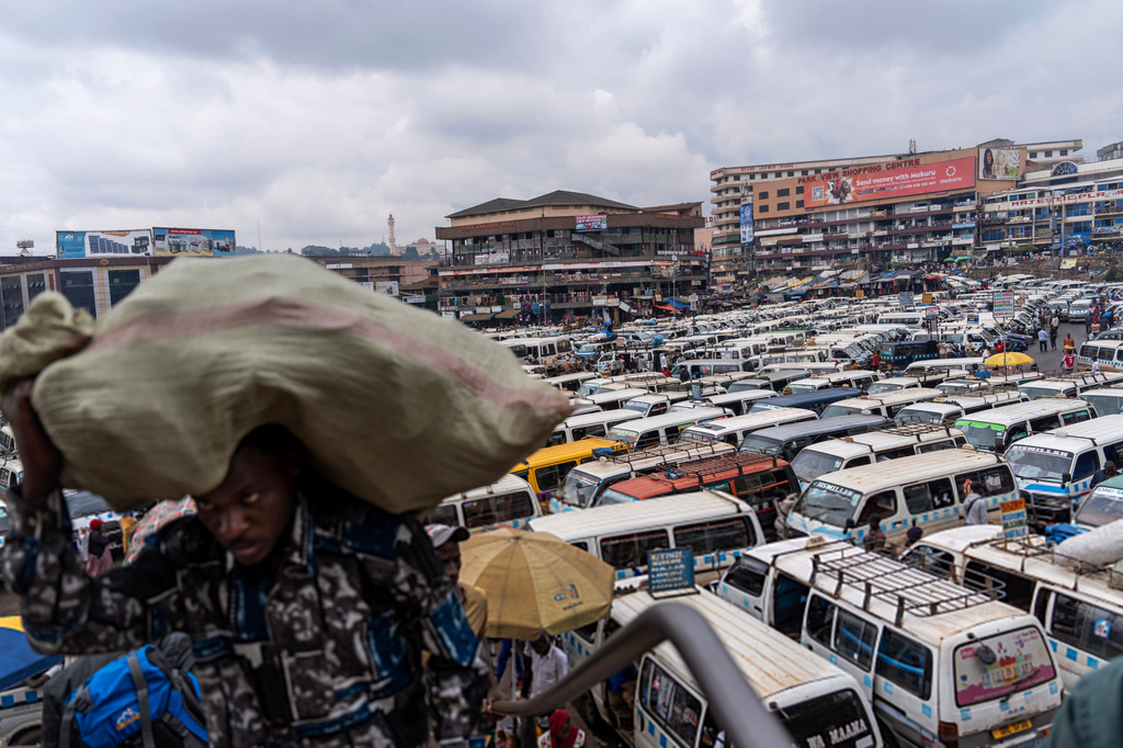 FILE - Minibuses fill the old taxi park near the largest market in Kampala, Uganda, Nov. 23, 2024. (AP Photo/David Goldman, File)