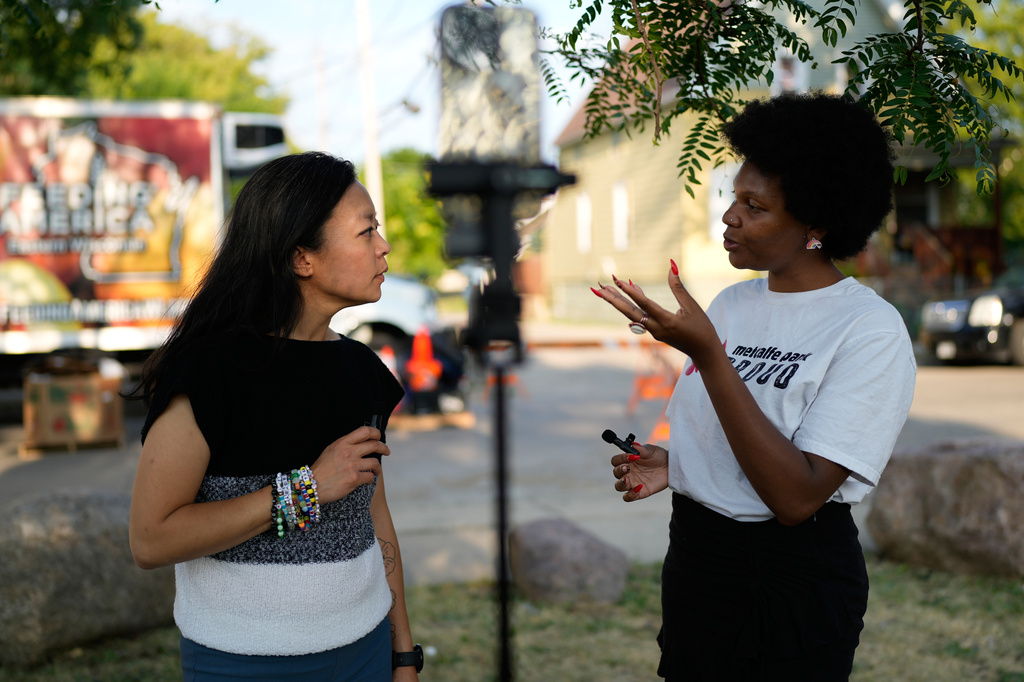 Democratic gubernatorial candidate Francesca Hong talks with Metcalfe Park Communications Representative Nateya Taylor, during "We Outside" Annual Community Event at Metcalfe Park Rising, Friday, July 24, 2026, in Milwaukee. (AP Photo/Nam Y. Huh)