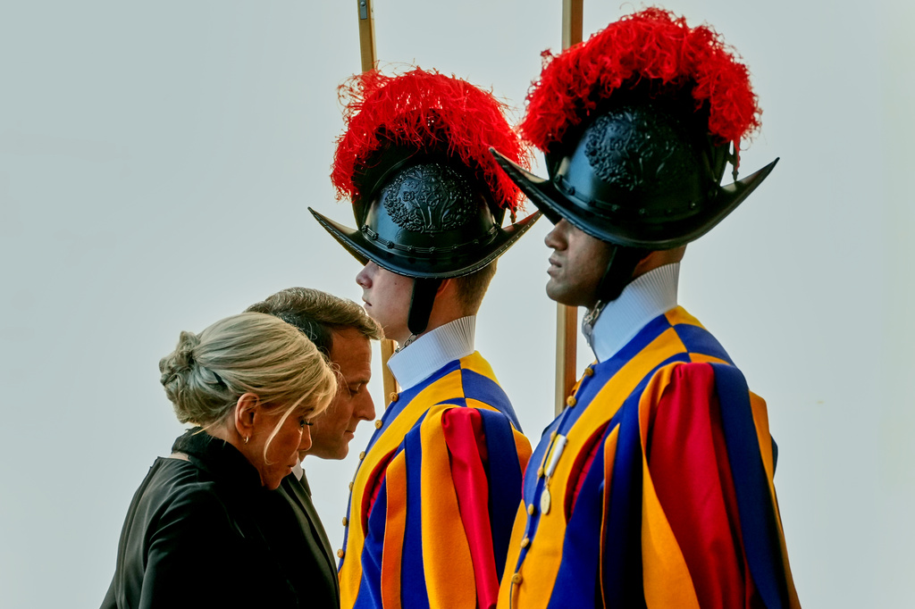 FILE - French President Emmanuel Macron and his wife Brigitte arrive in the St. Damasus Courtyard at the Vatican to meet with Pope Leo XIV, Friday, April 10, 2026. (AP Photo/Andrew Medichini, File)