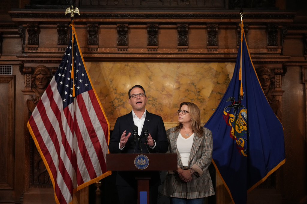 Pennsylvania Gov. Josh Shapiro, accompanied by his wife Lori Shapiro, speaks during a news conference after Cody Balmer plead guilty to attempted murder and other charges, on Tuesday, Oct. 14, 2025 in Harrisburg, Pa. (AP Photo/Matt Slocum)