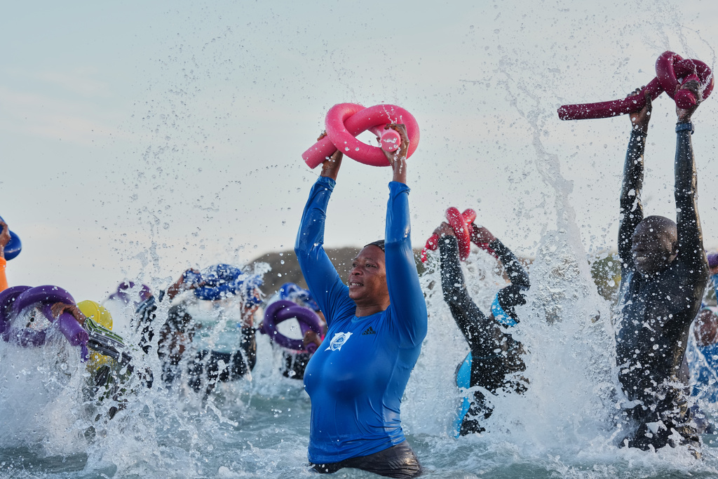 People take part in a group aquatic therapy session in the ocean in Dakar, Senegal, Saturday, Dec. 13, 2025. (AP Photo/Misper Apawu)