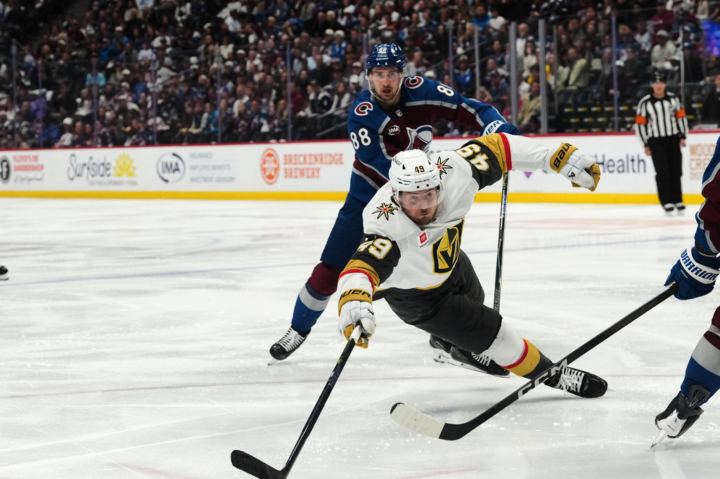 Vegas Golden Knights left wing Ivan Barbashev, front, falls after being tripped by Colorado Avalanche center Martin Necas (88) during the second period in Game 2 of the Western Conference finals NHL hockey Stanley Cup playoff series Friday, May 22, 2026, in Denver. (AP Photo/David Zalubowski)