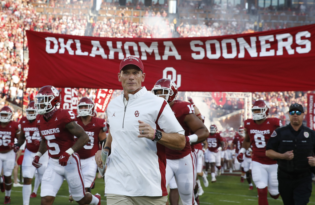 FILE - Oklahoma head coach Brent Venables runs onto the field with his team before the start of an NCAA college football game against Iowa State, Sept. 30, 2023, in Norman, Okla. (AP Photo/Alonzo Adams, File)