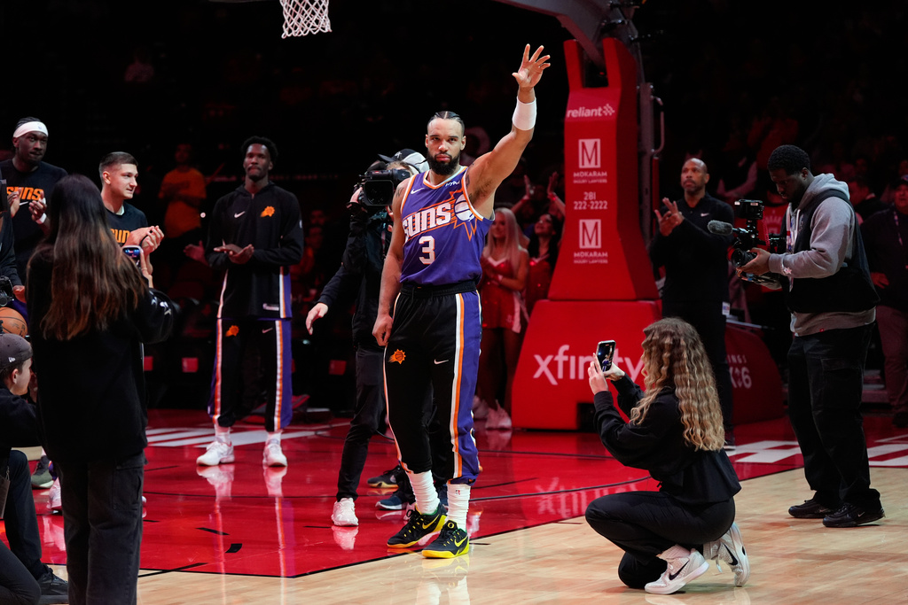 Phoenix Suns forward Dillon Brooks (3) waves after a tribute video played before an NBA basketball game against the Houston Rockets in Houston, Friday, Dec. 5, 2025. (AP Photo/Ashley Landis)