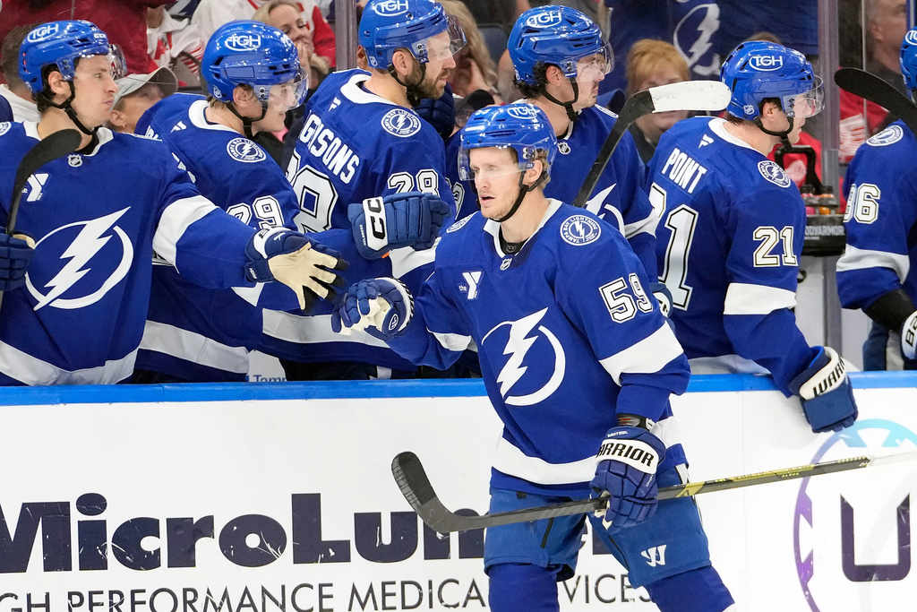 Tampa Bay Lightning center Jake Guentzel (59) celebrates his goal against the Detroit Red Wings with the bench during the third period of an NHL hockey game Thursday, March 12, 2026, at Benchmark International Arena in Tampa, Fla. (AP Photo/Chris O'Meara)