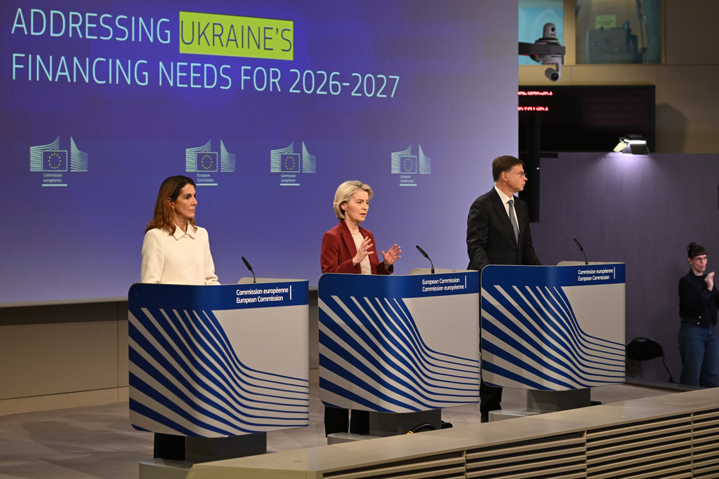 European Commission President Ursula von der Leyen, center, and European Commissioner for Economy and Productivity, Implementation and Simplification Valdis Dombrovskis, right, address a media conference regarding Ukraine's financing needs for 2026-2027 at EU headquarters in Brussels, Wednesday, Dec. 3, 2025. (AP Photo/Harry Nakos)