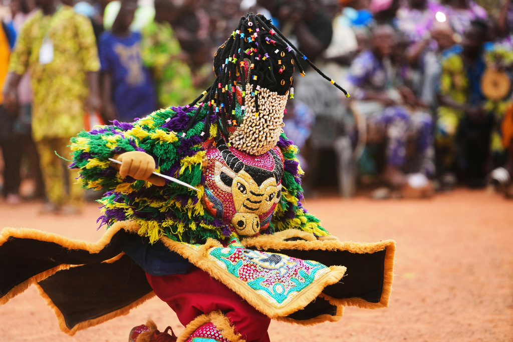 A man dressed in a costume dances during the mask festival in Porto Novo, Benin , Saturday, Aug. 2, 2025. (AP Photo/Sunday Alamba)