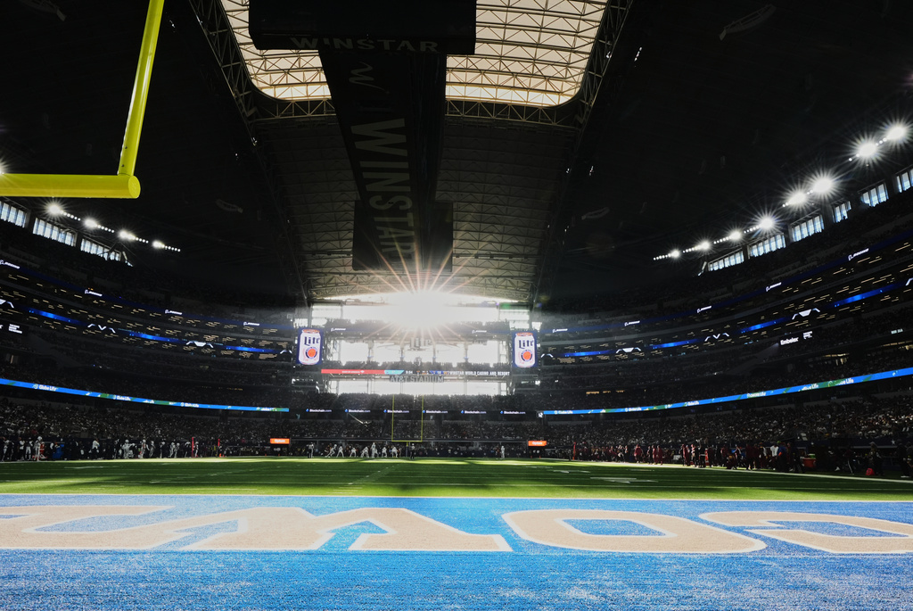 FILE - The sun shines through the West end zone windows during an NFL football game between the Washington Commanders and Dallas Cowboys Oct. 19, 2025, in Arlington, Texas. (AP Photo/Tony Gutierrez, File)