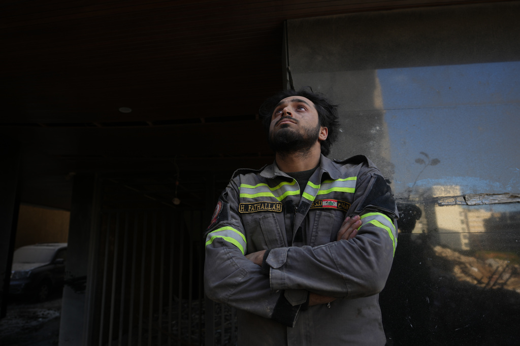 A Lebanese civil defense worker looks upward near the site of a building destroyed in an Israeli airstrike a day earlier in central Beirut, Lebanon, Thursday, April 9, 2026. (AP Photo/Hassan Ammar)