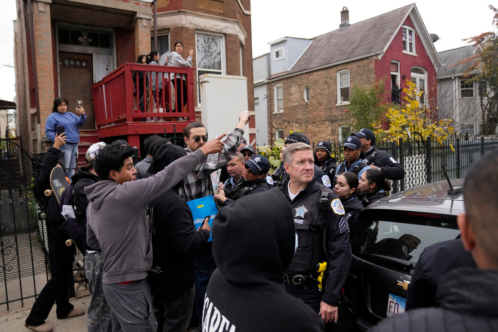 People protesting the actions of federal immigration agents in Little Village clash with Chicago police officers Saturday, Nov. 8, 2025, in Chicago. (AP Photo/Erin Hooley)