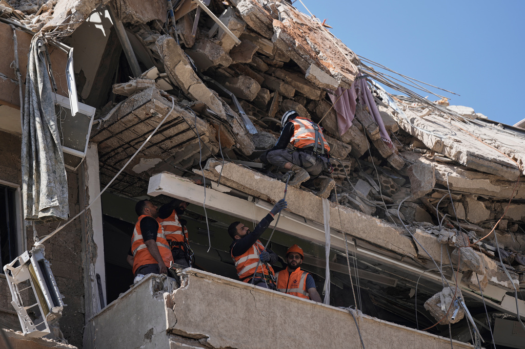Rescue workers search through the rubble of a building destroyed in an Israeli airstrike the previous day in Dahiyeh, Beirut's southern suburbs, Lebanon, Thursday, May 7, 2026. (AP Photo/Bilal Hussein)