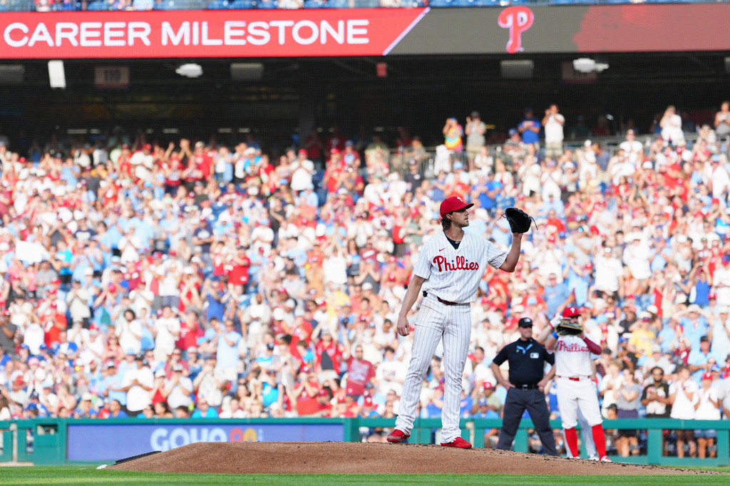 Philadelphia Phillies pitcher Aaron Nola receives a new ball after recording his 2,000th career strikeout during the second inning of a baseball game against the Toronto Blue Jays, Saturday, Aug. 8, 2026, in Philadelphia. (AP Photo/Derik Hamilton)