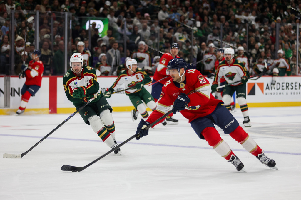 Florida Panthers' Sam Reinhart (13) controls the puck against the Minnesota Wild during the second period of an NHL hockey game, Saturday, Jan. 24, 2026, in St. Paul, Minn. (AP Photo/Lily Dozier)