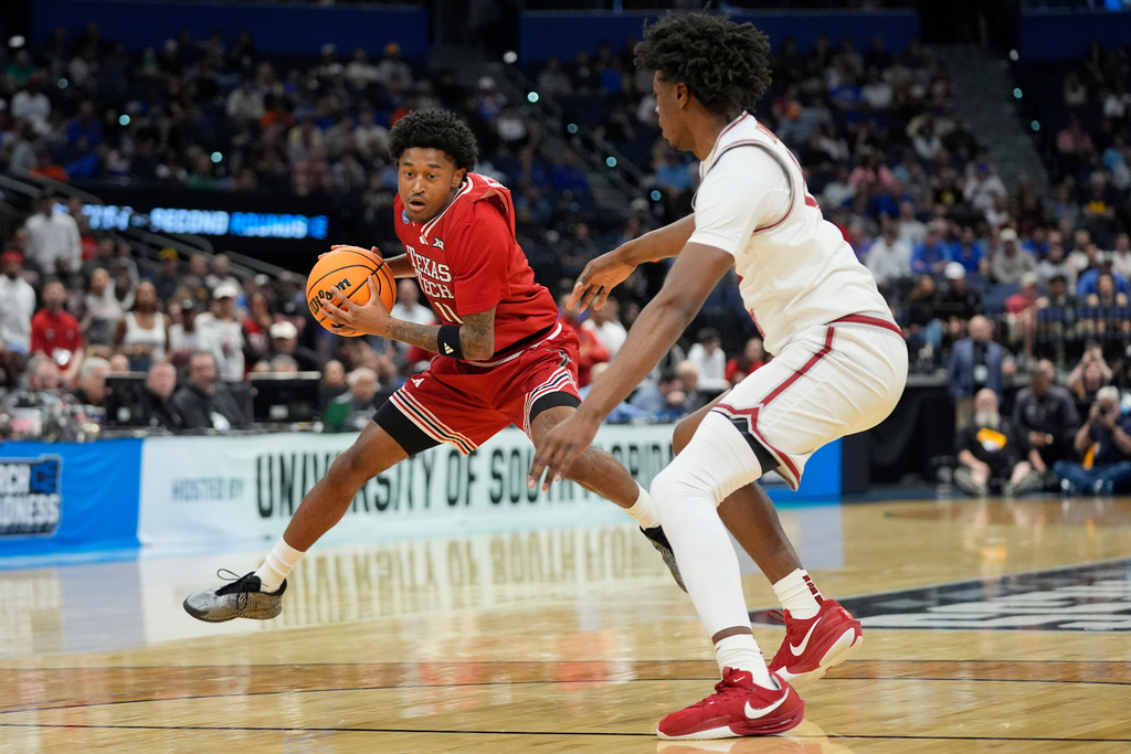 Texas Tech guard Jaylen Petty, left, moves the ball around Alabama forward London Jemison during the first half in the second round of the NCAA college basketball tournament, Sunday, March 22, 2026, in Tampa, Fla. (AP Photo/John Raoux)