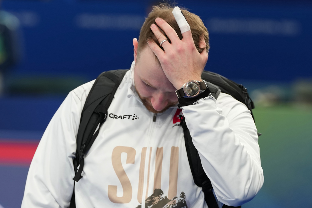 Switzerland's Yannick Schwaller reacts after losing to Britain in a men's curling semifinal match at the 2026 Winter Olympics, in Cortina d'Ampezzo, Italy, Thursday, Feb. 19, 2026. (AP Photo/Misper Apawu)