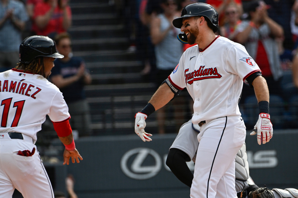 Cleveland Guardians' Jose Ramirez (11) congratulates Daniel Schneemann, right, for his two-run home run off Detroit Tigers starting pitcher Tarik Skubal during the third inning of a baseball game, Saturday, June 13, 2026, in Cleveland. (AP Photo/Phil Long)
