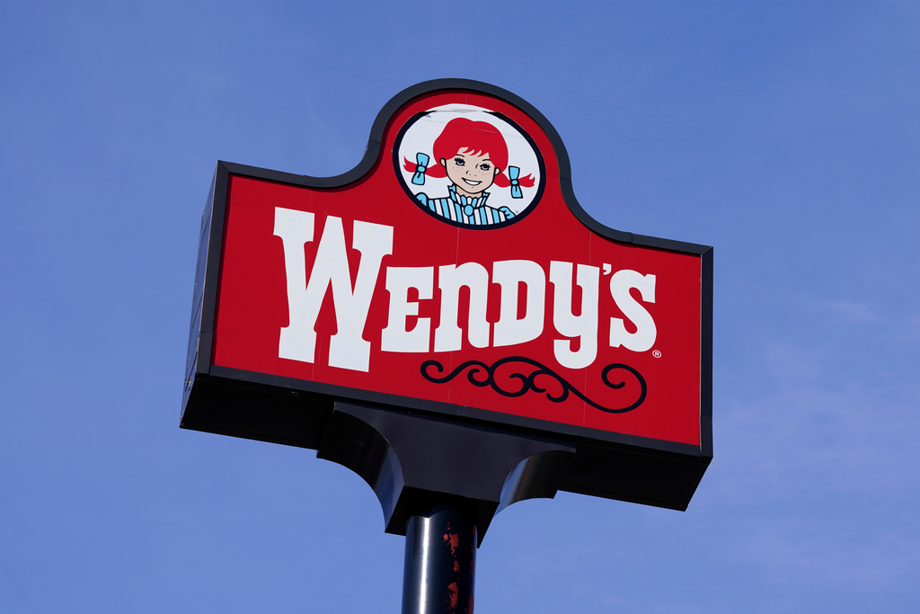 FILE - A sign stands over a Wendy's restaurant, Feb. 25, 2021, in Des Moines, Iowa. (AP Photo/Charlie Neibergall, File)