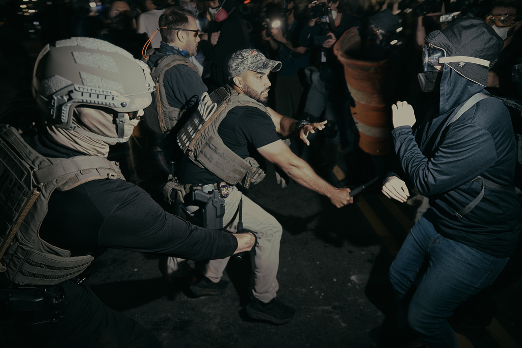 ICE agents use their baton as they clash with protesters outside the Delaney Hall detention center during a protest on Wednesday, May 27, 2026, in Newark, N.J. (AP Photo/Andres Kudacki)