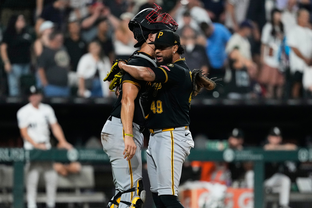 Pittsburgh Pirates relief pitcher Yohan Ramírez, right, hugs catcher Rafael Flores Jr. after the seventh inning of a baseball game against the Chicago White Sox in Chicago, Wednesday, Sept. 9, 2026. (AP Photo/Nam Y. Huh)