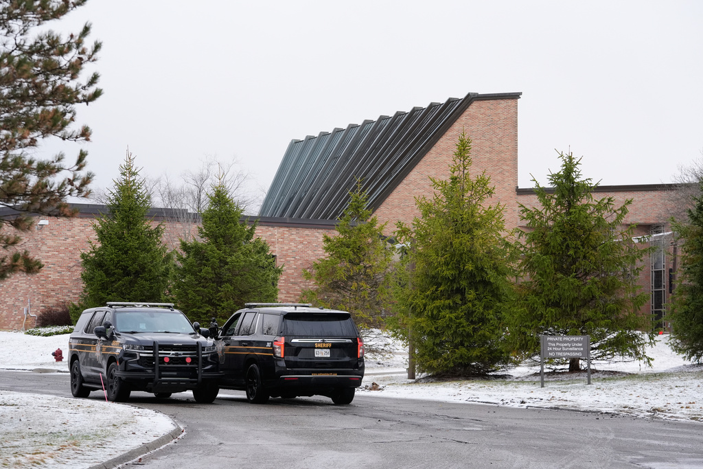 Police vehicles sit outside the Temple Israel synagogue Friday, March 13, 2026, in West Bloomfield Township, Mich. (AP Photo/Paul Sancya)