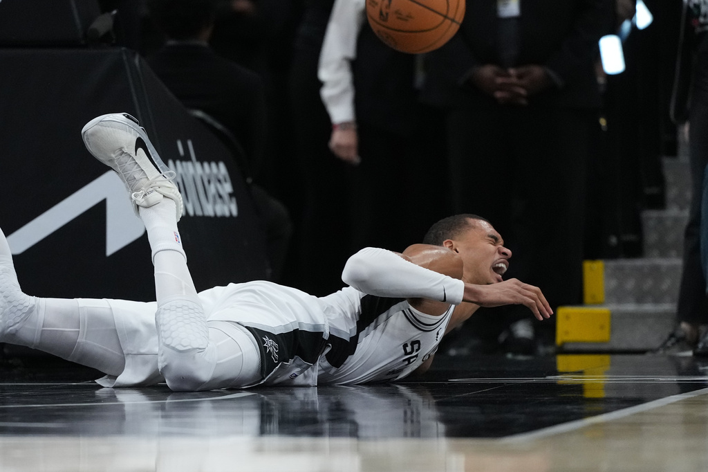 San Antonio Spurs forward Victor Wembanyama (1) takes a hard fall on the court during the first half in Game 2 of a first-round NBA playoffs basketball series against the Portland Trail Blazers in San Antonio, Tuesday, April 21, 2026. (AP Photo/Eric Gay)