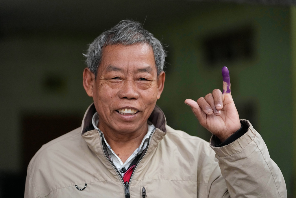 A voter shows his finger, marked with ink to indicate he voted, at a polling station during the second phase of general election in Mandalay, central Myanmar, Sunday, Jan. 11, 2026. (AP Photo/Aung Shine Oo)