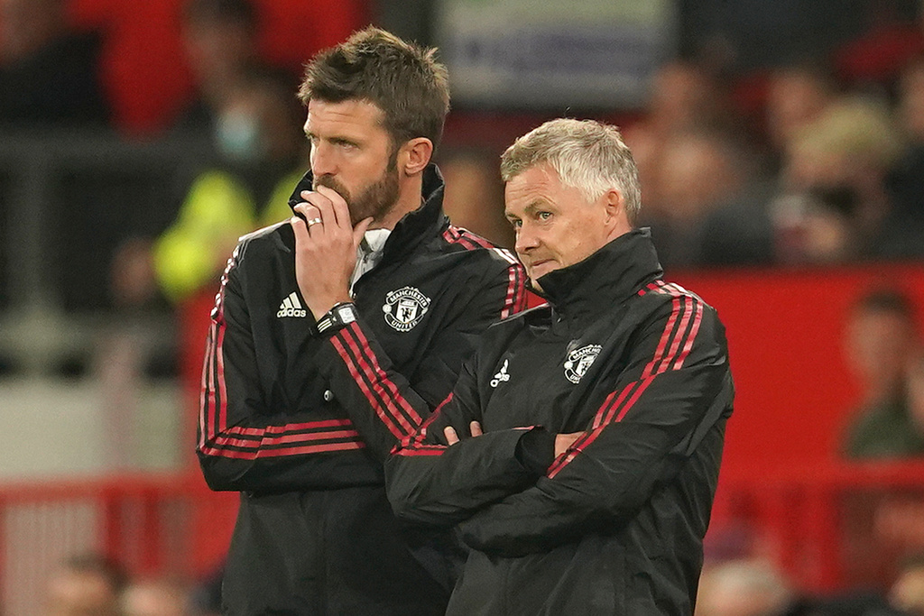 FILE - Manchester United's manager Ole Gunnar Solskjaer, right, and assistant Michael Carrick stand on the touchline during the English League Cup soccer match between Manchester United and West Ham at Old Trafford in Manchester, England, Wednesday, Sept. 22, 2021. (AP Photo/Dave Thompson, File)
