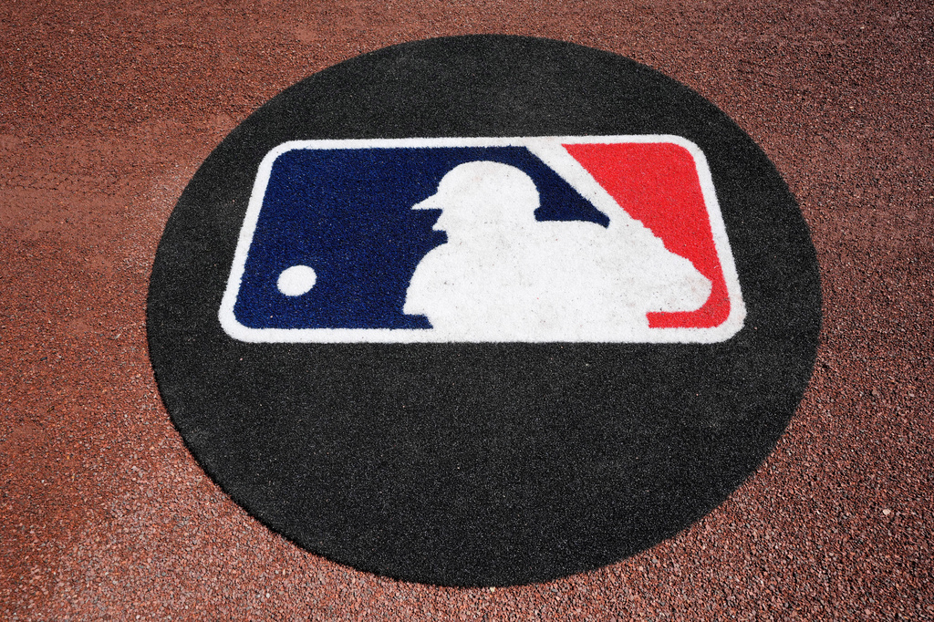 FILE - THe Major League Baseball logo is seen on the field before a spring training baseball game between the Pittsburgh Pirates and the Atlanta Braves Tuesday, Feb. 27, 2024, in Bradenton, Fla. (AP Photo/Charlie Neibergall, File)