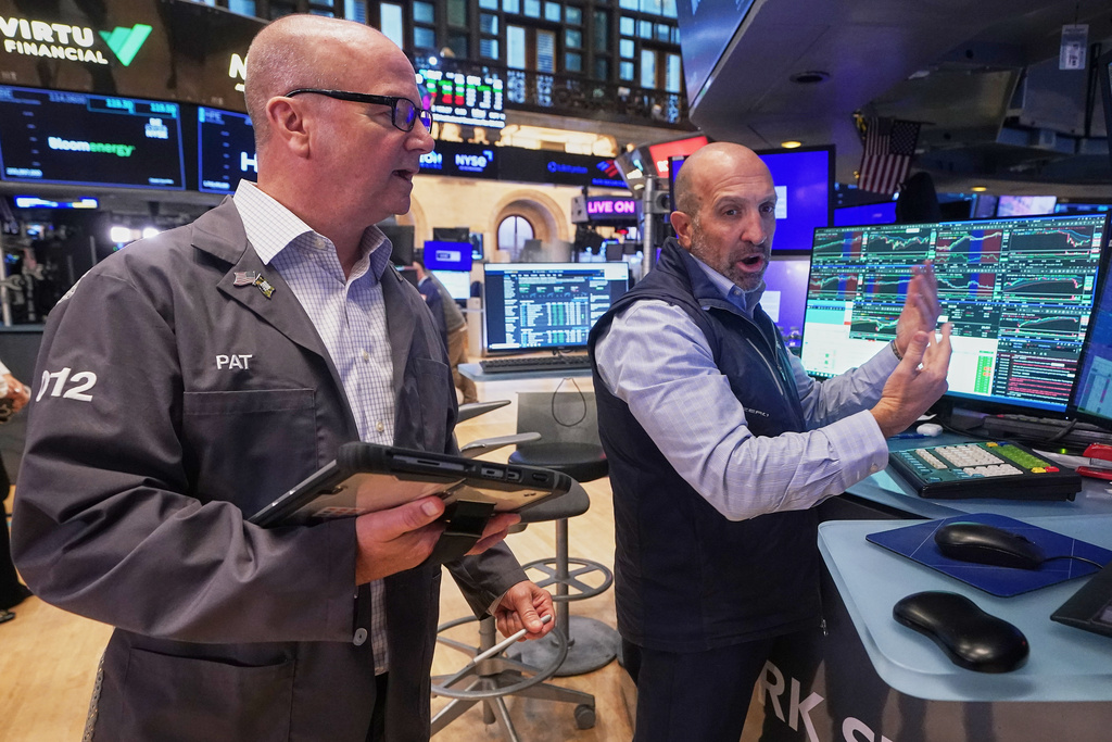 Trader Patrick Casey, left, and specialist James Denaro work on the floor of the New York Stock Exchange, Wednesday, Oct. 15, 2025. (AP Photo/Richard Drew)