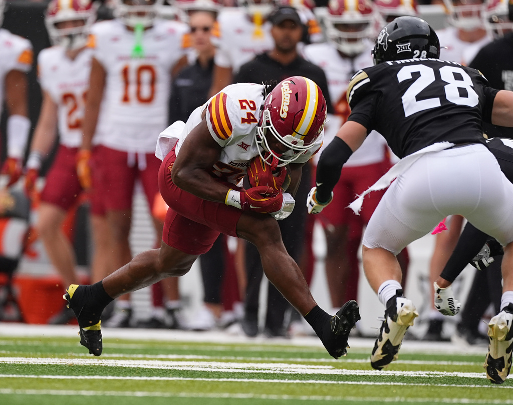 Iowa State running back Abu Sama, left, runs for a short gain as Colorado defensive back Ben Finneseth comes in for a tackle in the first half of an NCAA college football game Saturday, Oct. 11, 2025, in Boulder, Colo. (AP Photo/David Zalubowski)