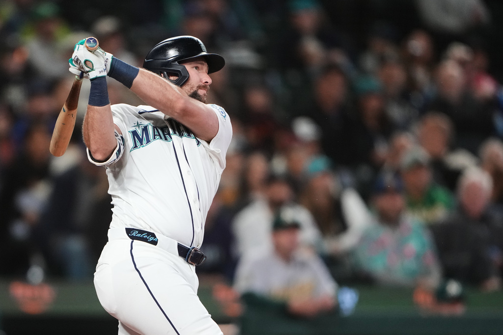 Seattle Mariners' Cal Raleigh follows through on a solo home run against the Athletics during the third inning of a baseball game, Wednesday, April 22, 2026, in Seattle. (AP Photo/Lindsey Wasson)
