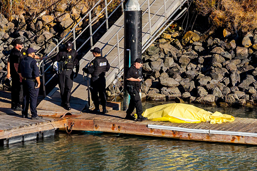 First responders stand near a body after a boat accident near Alcatraz Island off San Francisco, Tuesday, July 14, 2026. (AP Photo/Noah Berger)