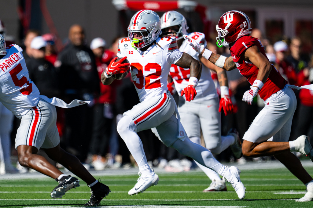 Ohio State running back Isaiah West (32) makes a run into the Indiana secondary during the second half of an NCAA college football game, Saturday, Oct. 17, 2026, in Bloomington, Ind. (AP Photo/Doug McSchooler)