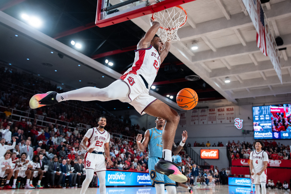 St. John's forward Zuby Ejiofor (24) dunks during the second half of an NCAA college basketball game against Quinnipiac, Monday, Nov. 3, 2025, in New York. (AP Photo/Angelina Katsanis)