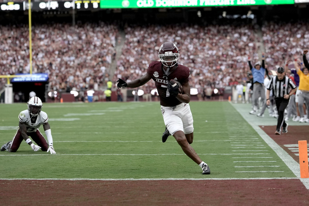 Texas A&M wide receiver Isaiah Horton (7) breaks free from a tackle attempt by Missouri State cornerback Joel Kpassou (8) for a touchdown run during the first quarter of an NCAA college football game Saturday, Sept. 5, 2026, in College Station, Texas. (AP Photo/Sam Craft)