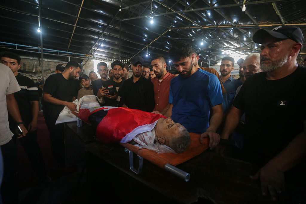 Palestinians mourn over the body of Mohamed al-Wahidi, director of public relations for the Egyptian Committee in Gaza, who was killed in an Israeli military strike, during his funeral at the Great Omari Mosque in Gaza City, Wednesday, July 8, 2026. (AP Photo/Yousef Al Zanoun)
