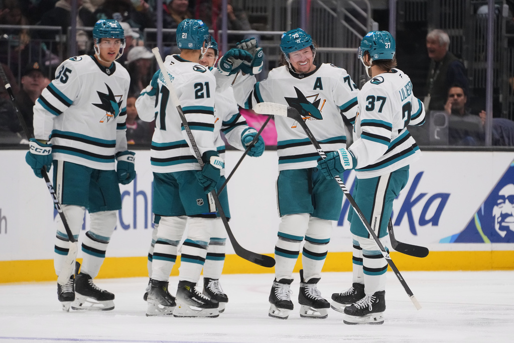 San Jose Sharks center Tyler Toffoli, second from right, celebrates his goal against the Seattle Kraken with teammates, including defenseman Timothy Liljegren (37), center Alexander Wennberg (21) and defenseman Shakir Mukhamadullin (85) during the third period of an NHL hockey game Wednesday, Nov. 5, 2025, in Seattle. (AP Photo/Lindsey Wasson)