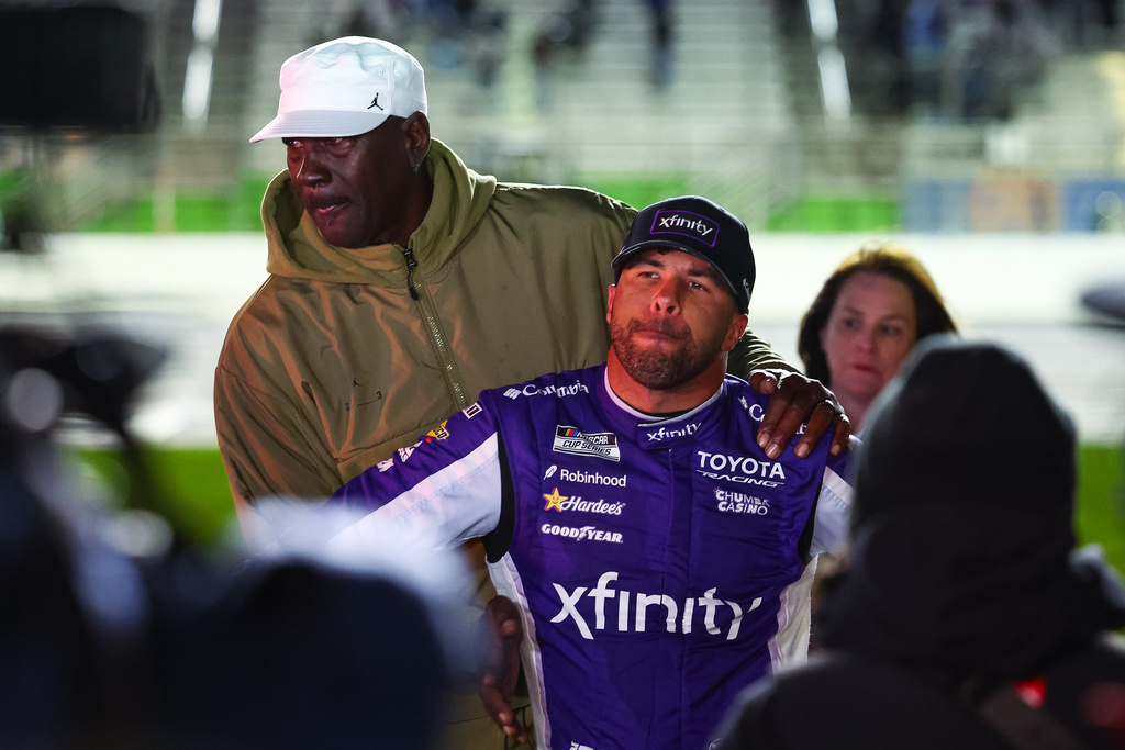 23XI Racing co-owner Michael Jordan, left, reacts with Bubba Wallace, right, after a NASCAR Cup Series auto race, Sunday, Feb. 22, 2026, in Hampton, Ga. (AP Photo/Colin Hubbard)