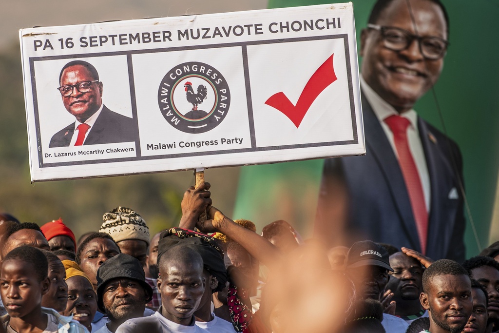 Malawi Congress Party (MCP) supporters hold a poster showing Malawi President Lazarus Chakwera at a campaign rally in Blantyre, Malawi, Sunday, Sept. 7, 2025. (AP Photo/Thoko Chikondi)