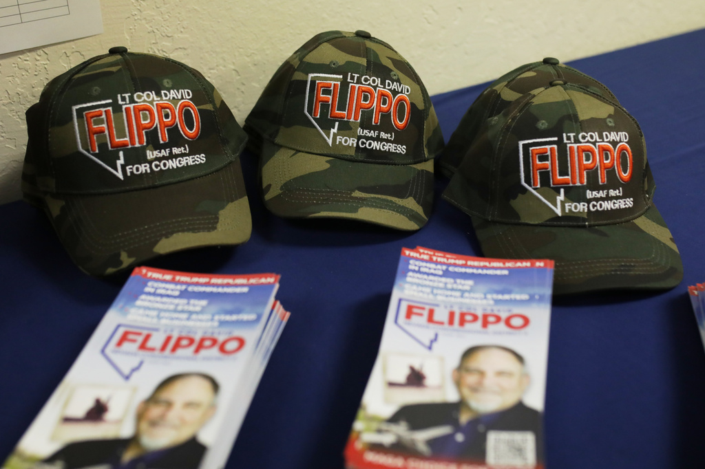 Hats and pamphlets sit on a table during a primary election night watch party for David Flippo, a Republican candidate for Congress in Nevada's 2nd district, Tuesday, June 9, 2026, in Reno, Nev. (AP Photo/William Hale Irwin)
