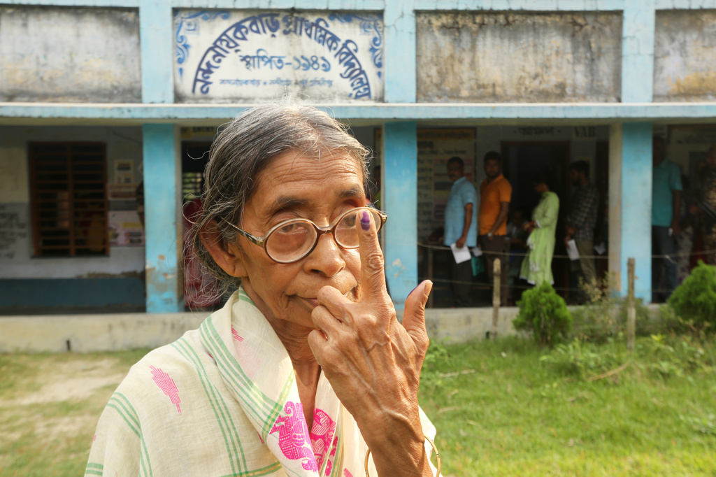 An elderly voter poses for a photograph after casting her vote during the first phase of polling in Nandigram, in West Bengal state, India, Thursday, April 23, 2026. (AP Photo/Bhaskar Mallick)
