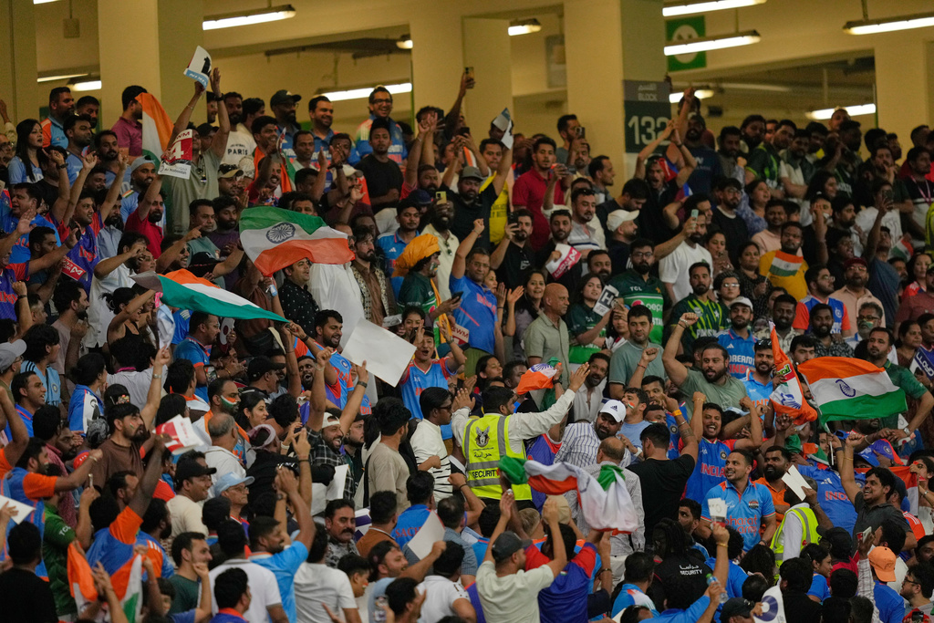 A private security guard pacifies India and Pakistani fans during the Asia Cup cricket final between India and Pakistan at Dubai International Cricket Stadium, United Arab Emirates, Sunday, Sept. 28, 2025. (AP Photo/Altaf Qadri)
