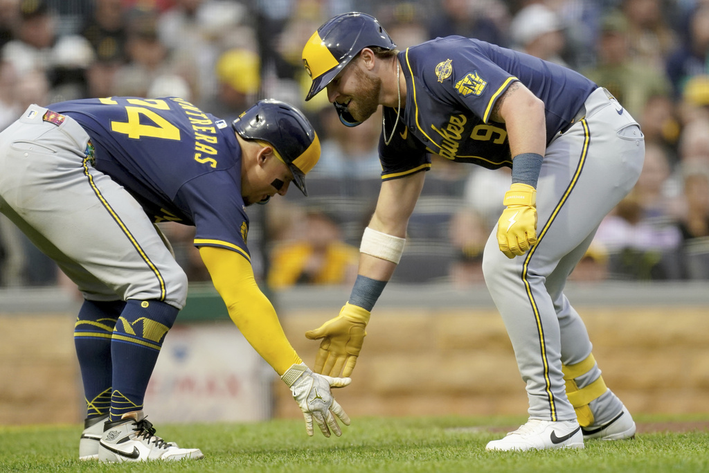 Milwaukee Brewers' Jake Bauers, right, is greeted by William Contreras, left, after hitting a two-run home run during the fourth inning of a baseball game against the Pittsburgh Pirates, Saturday, Sept. 6, 2025, in Pittsburgh. (AP Photo/Matt Freed)