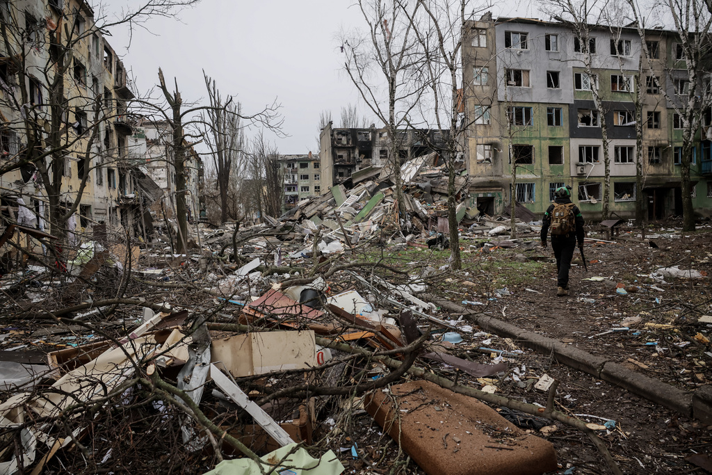 In this photo taken on Saturday Dec. 20, 2025 and provided by Ukraine's 24th Mechanized Brigade press service, a soldier walks through the ruins of the town of Kostyantynivka, in the Donetsk region, Ukraine. (Oleg Petrasiuk/Ukraine's 24th Mechanized Brigade via AP)