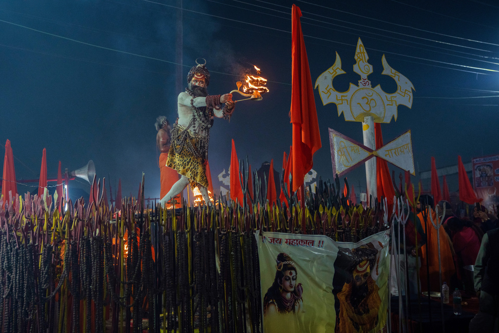 A Hindu holy man prays on the eve of Mauni Amavasya, a divine occasion in Hindu religious practice followed for honoring ancestors or forefathers, at the Sangam, the confluence of the Ganges, the Yamuna and the mythical Saraswati rivers, during the annual month long Hindu religious fair "Magh Mela" in Prayagraj, India, Saturday, Jan.17, 2026. (AP Photo/Rajesh Kumar Singh)