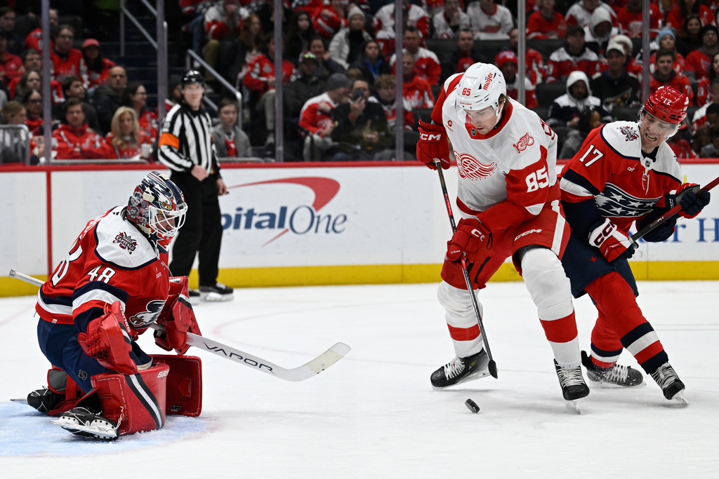 Detroit Red Wings left wing Elmer Soderblom (85) moves past Washington Capitals center Dylan Strome (17) to score a goal against Washington Capitals goaltender Logan Thompson during the second period of an NHL hockey game, Saturday, Dec. 20, 2025, in Washington. (AP Photo/John McDonnell)