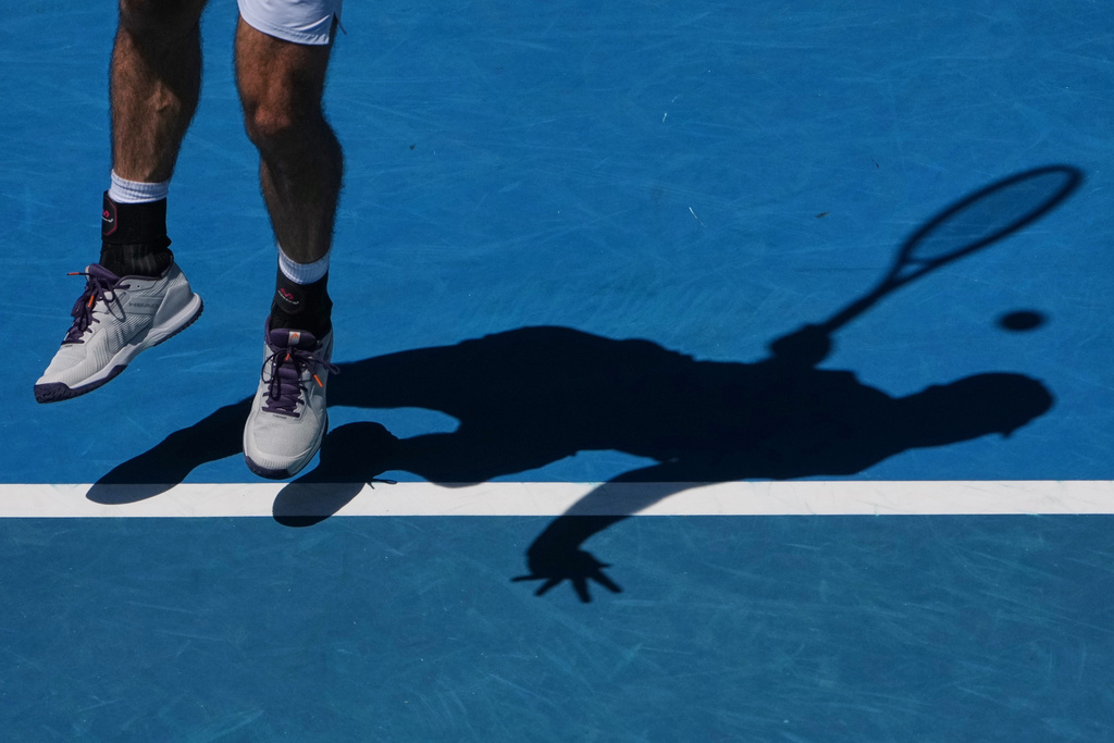 Nuno Borges of Portugal serves to Felix Auger-Aliassime of Canada during their first round match at the Australian Open tennis championship in Melbourne, Australia, Monday, Jan. 19, 2026. (AP Photo/Asanka Brendon Ratnayake)