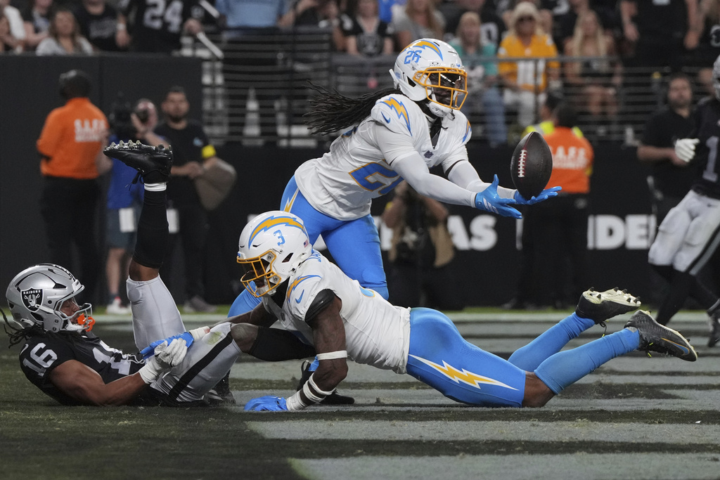 Los Angeles Chargers cornerback Donte Jackson (26) intercepts a pass intended for Las Vegas Raiders wide receiver Jakobi Meyers (16) during the second half of an NFL football game, Monday, Sept. 15, 2025, in Las Vegas. (AP Photo/Rick Scuteri)