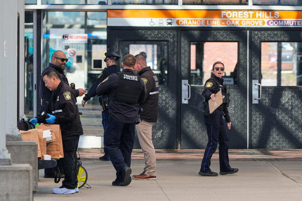 Law enforcement officials work a crime scene at the Forest Hills train station in the Jamaica Plain neighborhood, Friday, March 20, 2026, in Boston. (AP Photo/Charles Krupa)