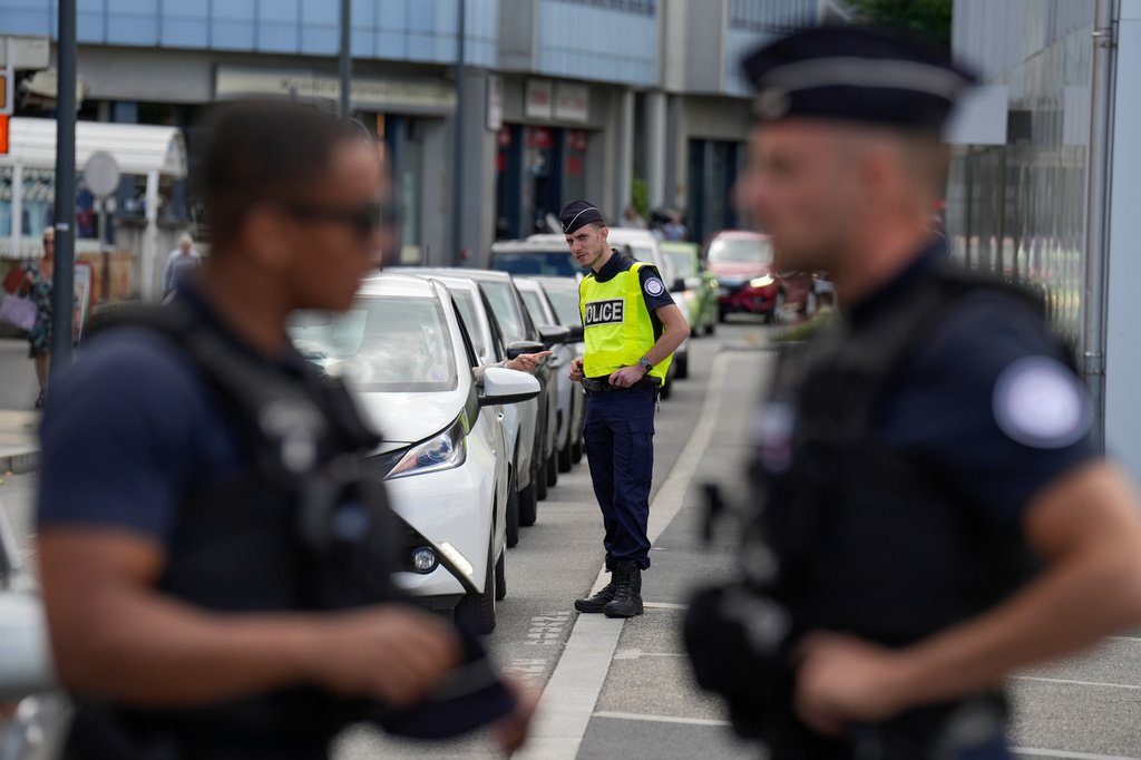 French police officers check cars crossing the border between Geneva and the French town of Gaillard, France, Wednesday, June 10, 2026, ahead of the upcoming G7 summit due to take place June 15-17 in the town of Evian-les-Bains. (AP Photo/Baz Ratner)